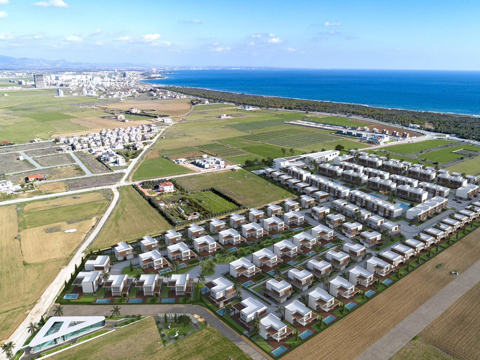 La Isla complex from above: villas, pools and the sea on the horizon