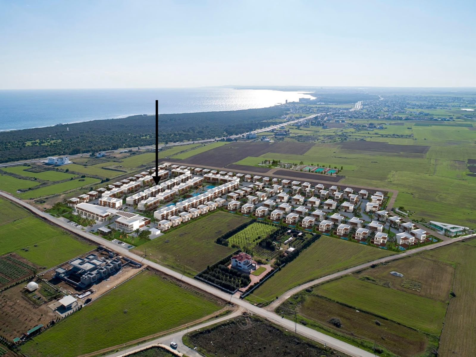 Aerial view of the La Isla complex marking the building's location, sea in the background