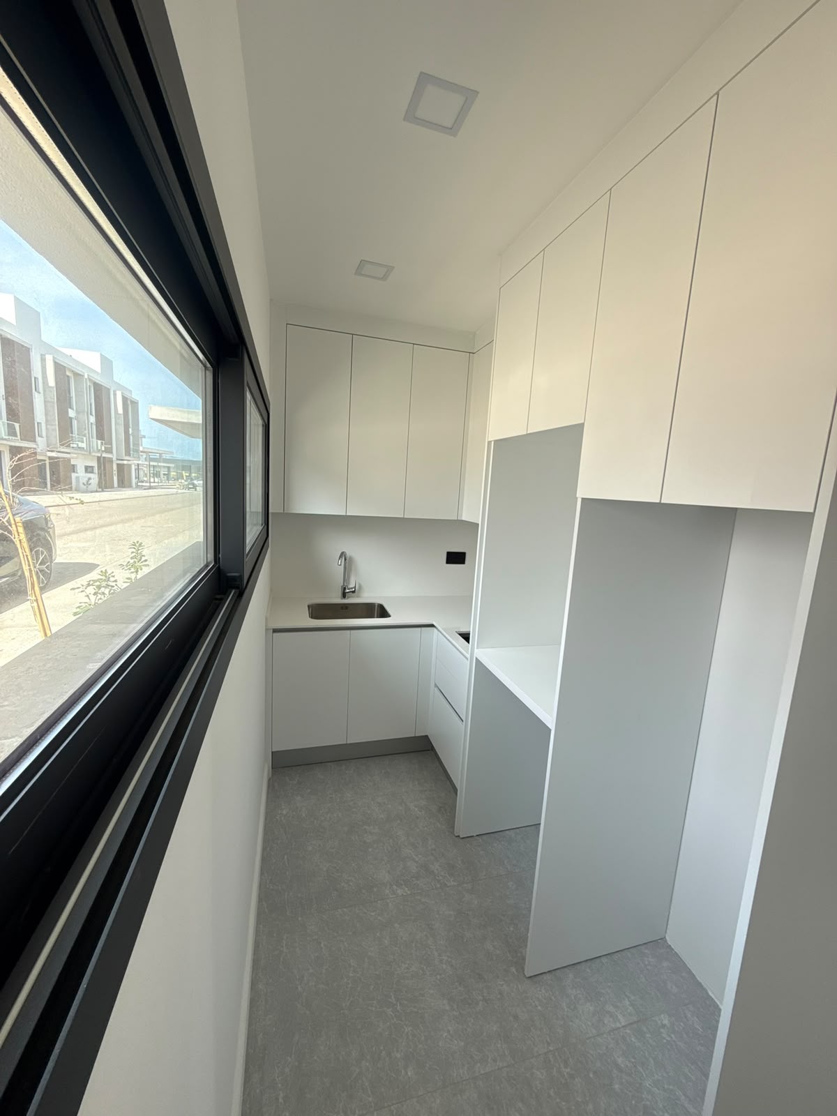 Utility room with a sink and built-in cabinets