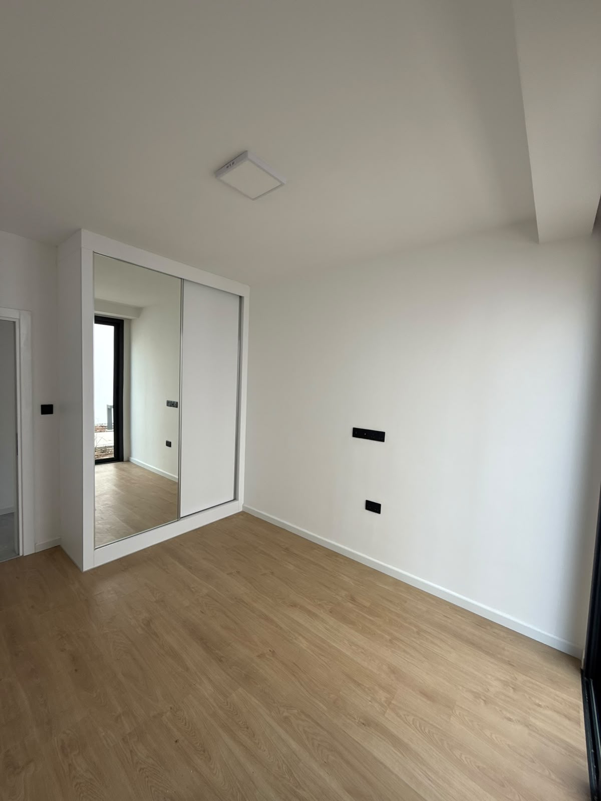 Bedroom with a mirrored sliding wardrobe