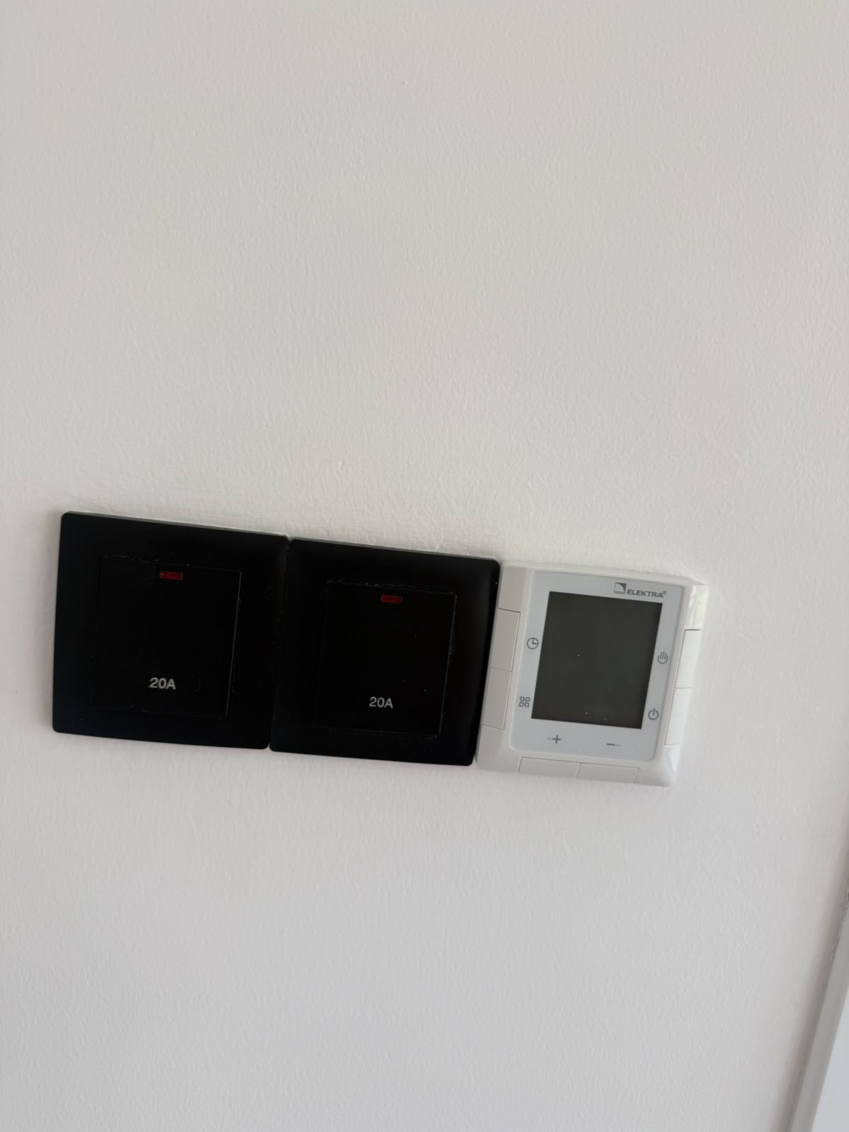 Wall switches and an Elektra underfloor-heating thermostat