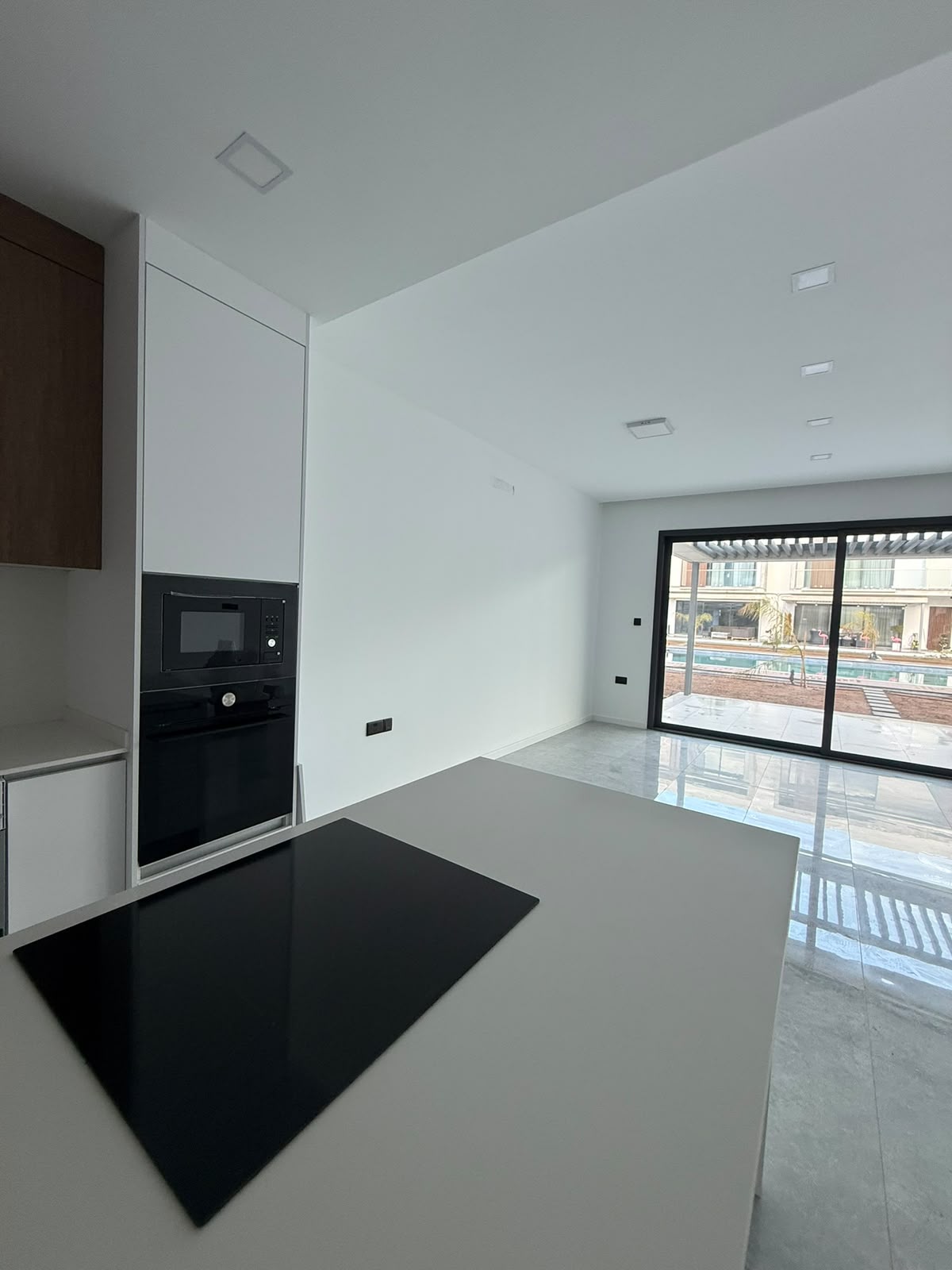 Kitchen with a view of the pool and terrace through the sliding doors