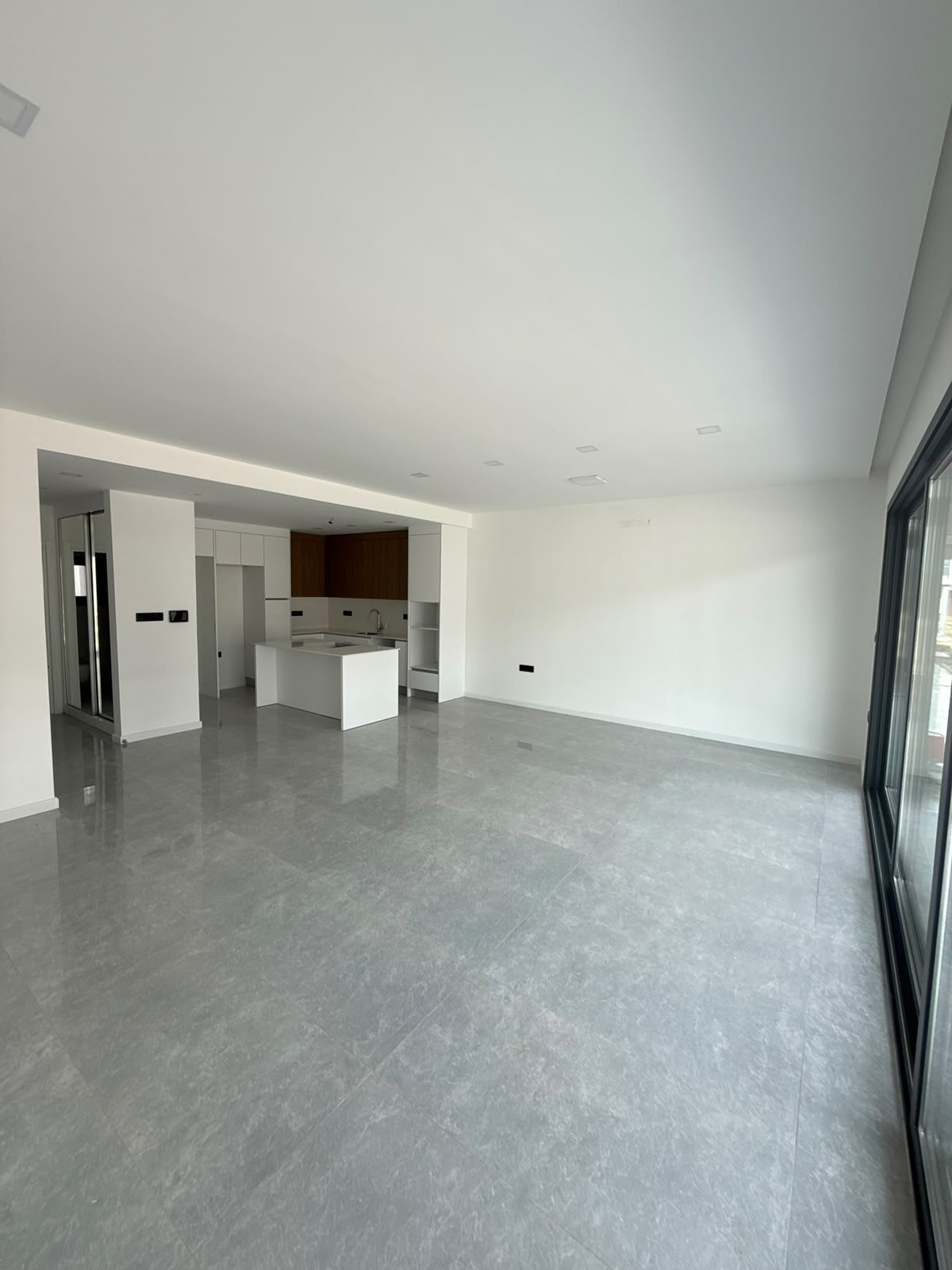 Open-plan living-kitchen area, view toward the terrace and pool