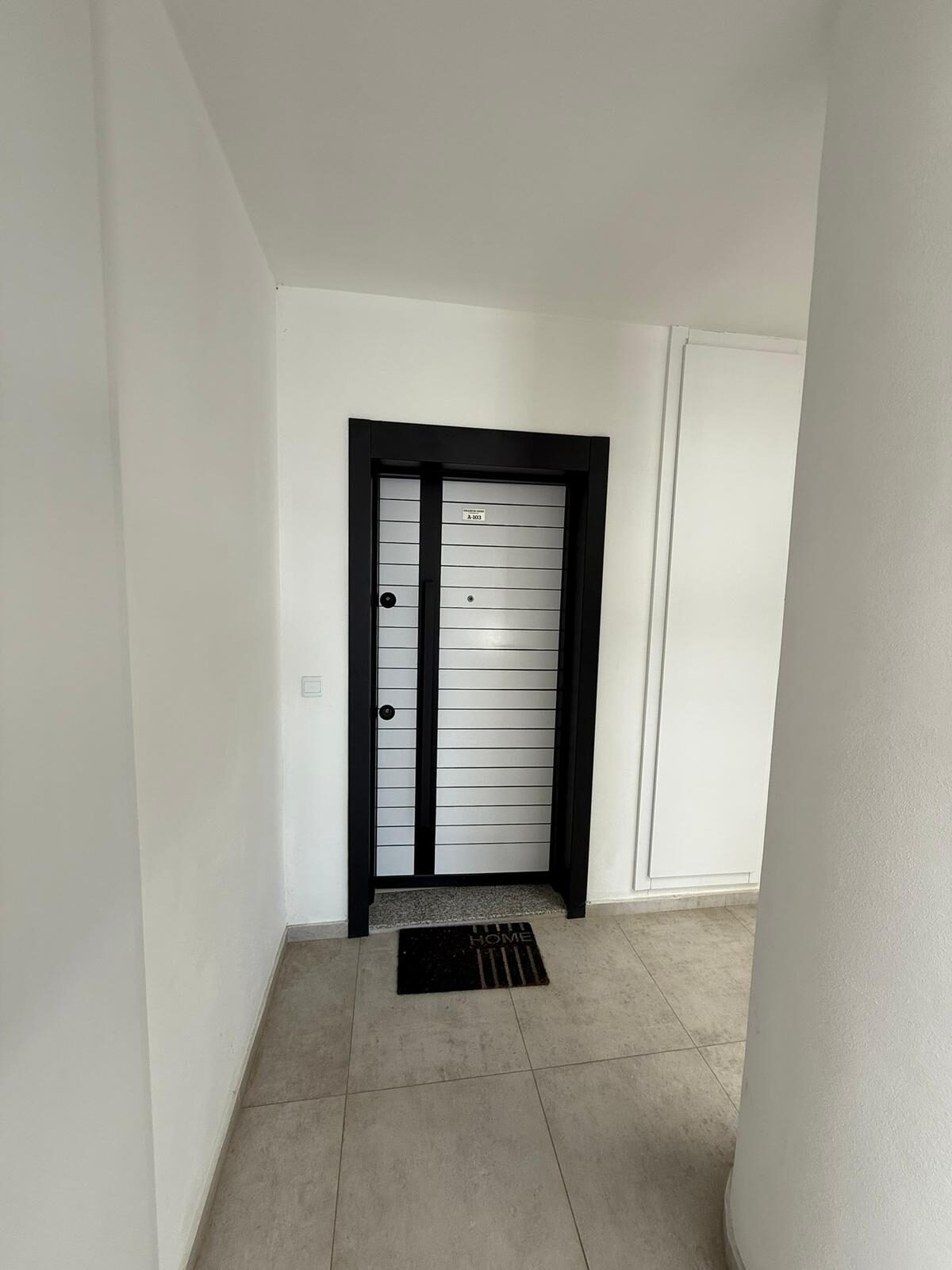 Front door of apartment A-103 in the complex stairwell
