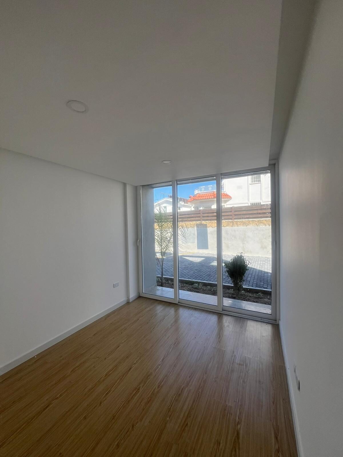 Bedroom with access to a paved yard through a panoramic door