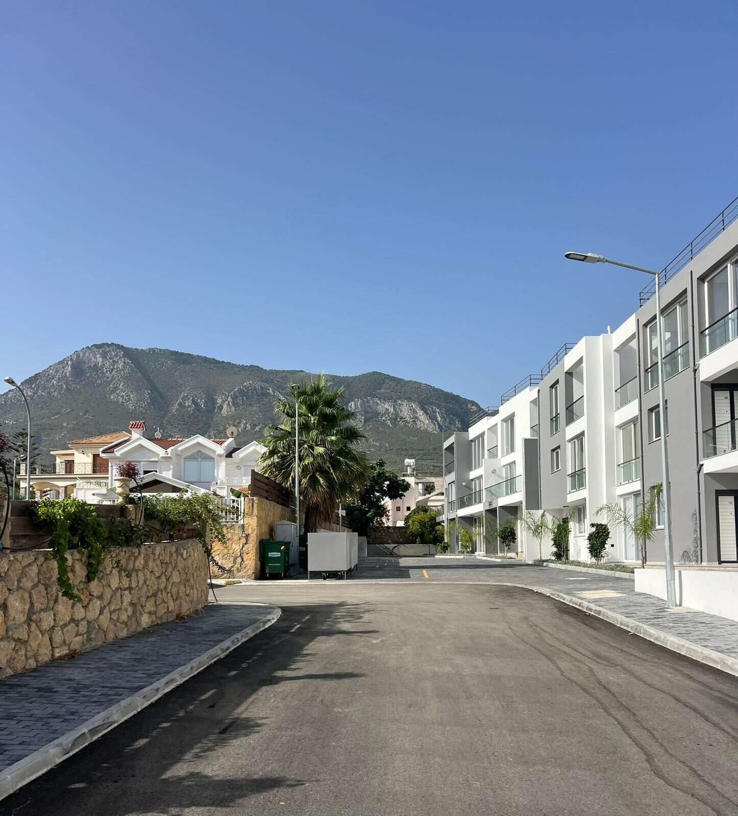 Street inside the Coliseum Court complex with the Pentadaktylos mountains in the background