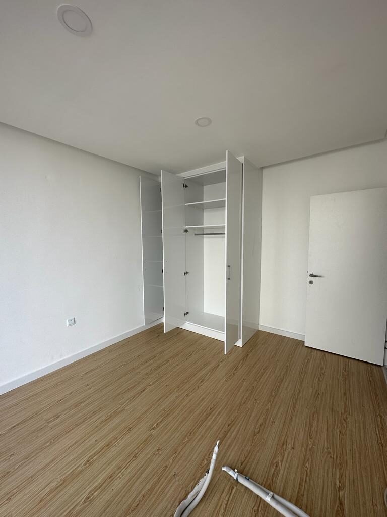 Bedroom with a built-in wardrobe, doors open
