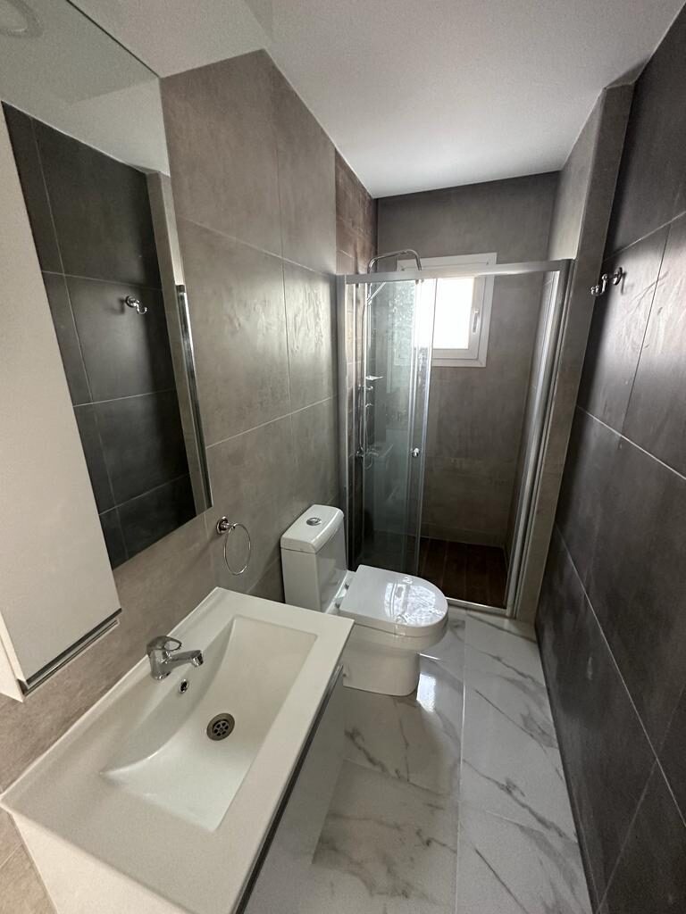 Bathroom of the apartment: shower cabin, toilet and sink