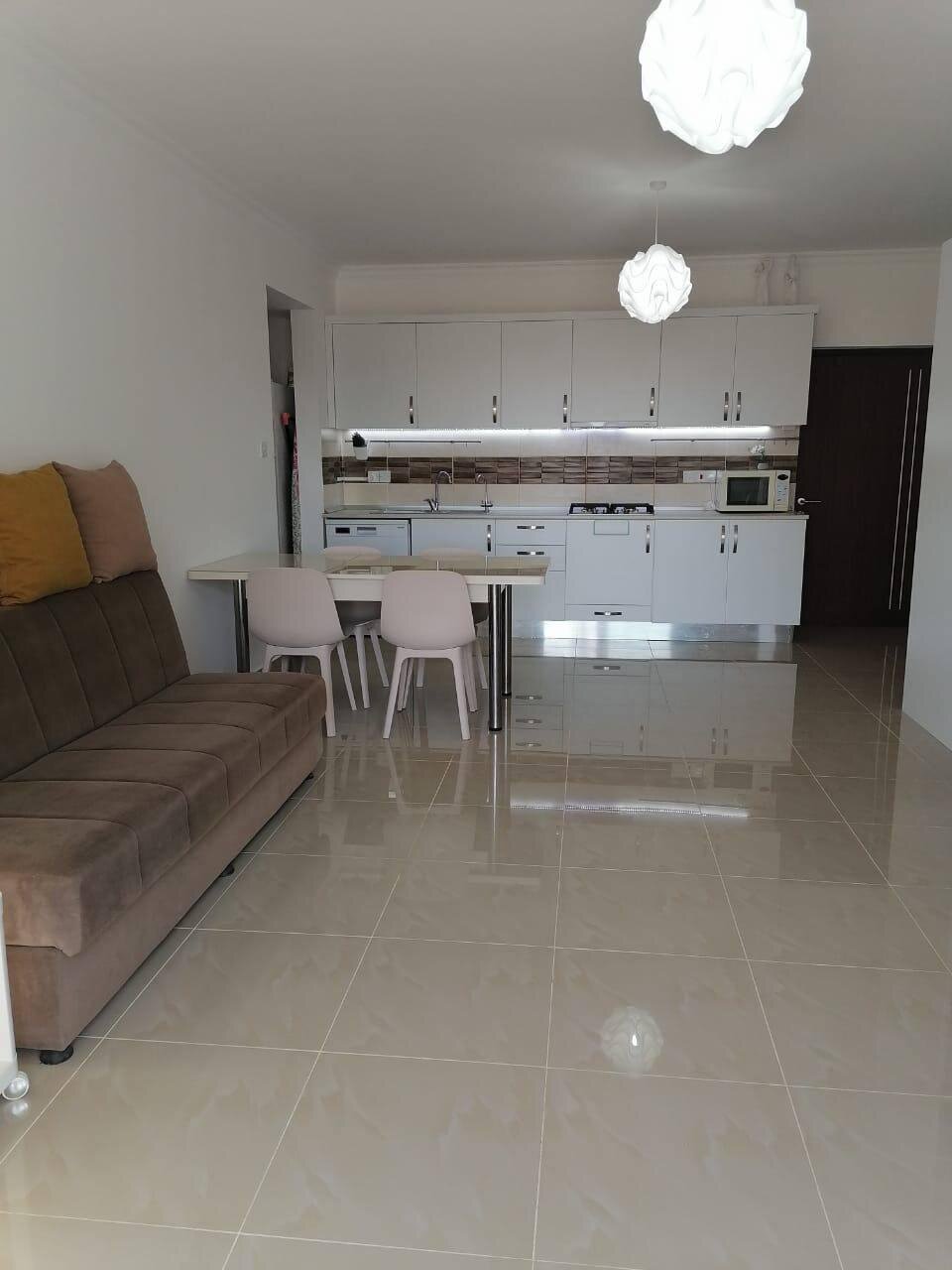 Sofa and dining table against the open-plan kitchen