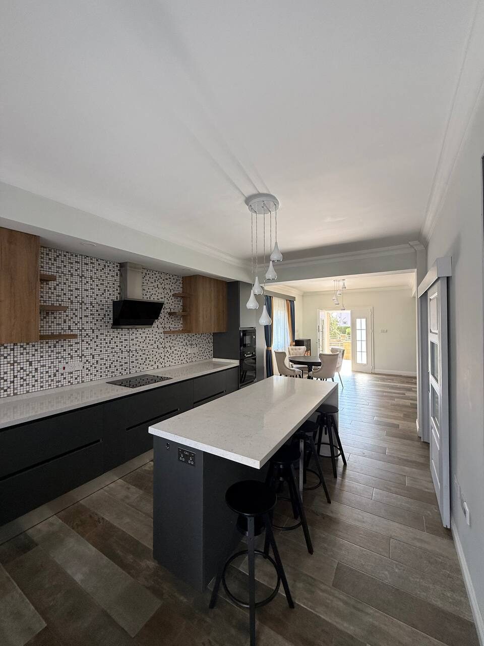 Kitchen with a breakfast-bar island and high stools