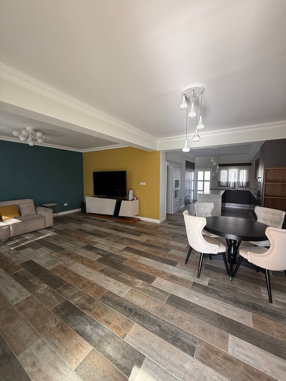 Living room with a television and dining area, windows onto the garden