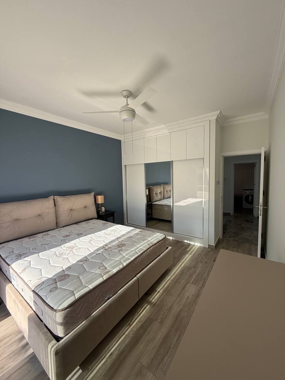 Bedroom with a double bed, fitted wardrobe and ceiling fan