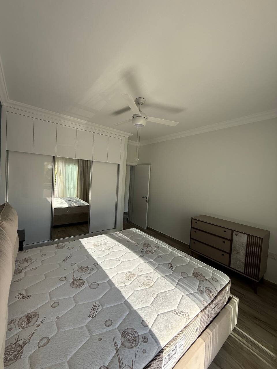 Bedroom with a fitted wardrobe and ceiling fan