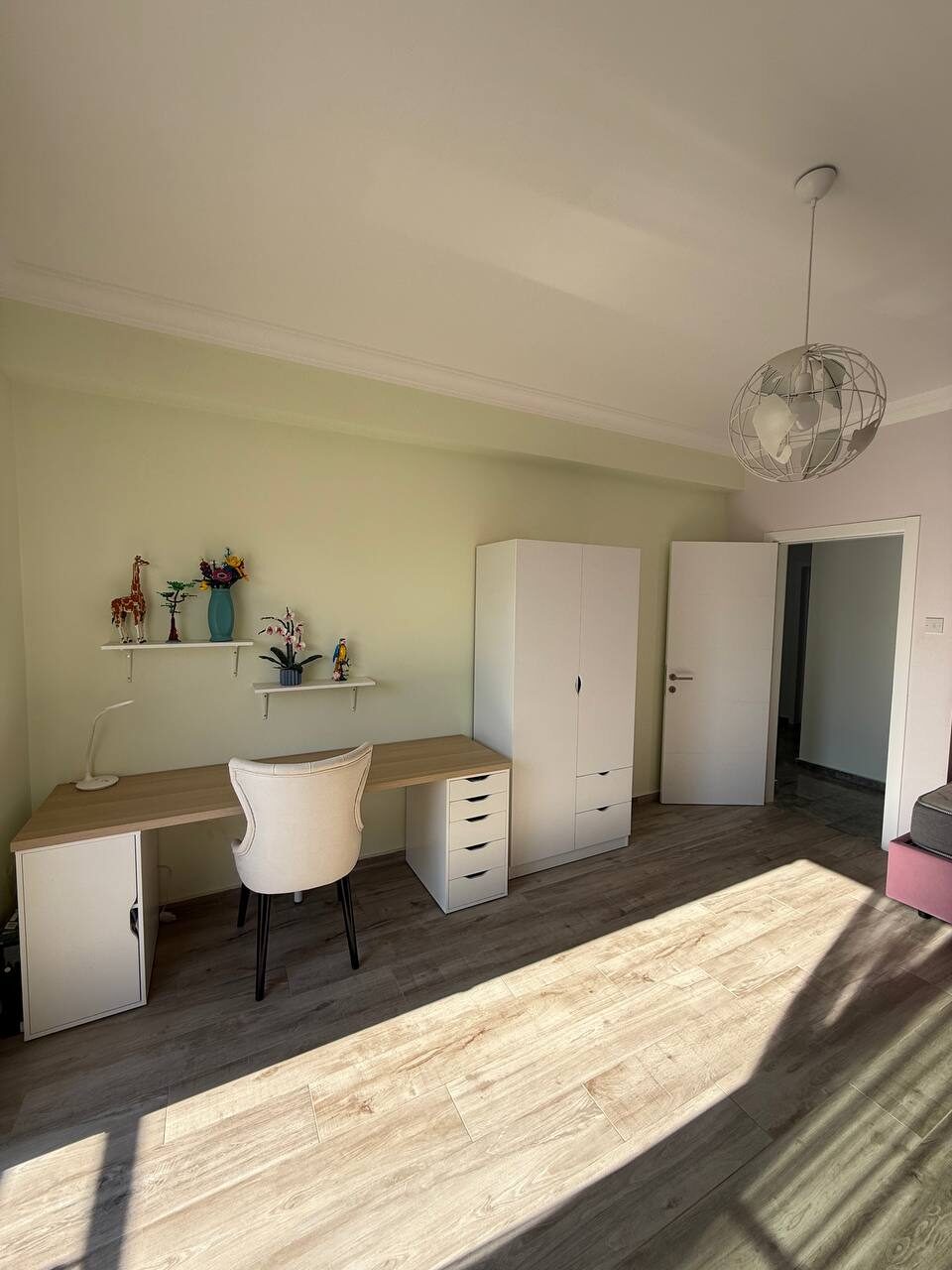 Room with a desk and a fitted wardrobe