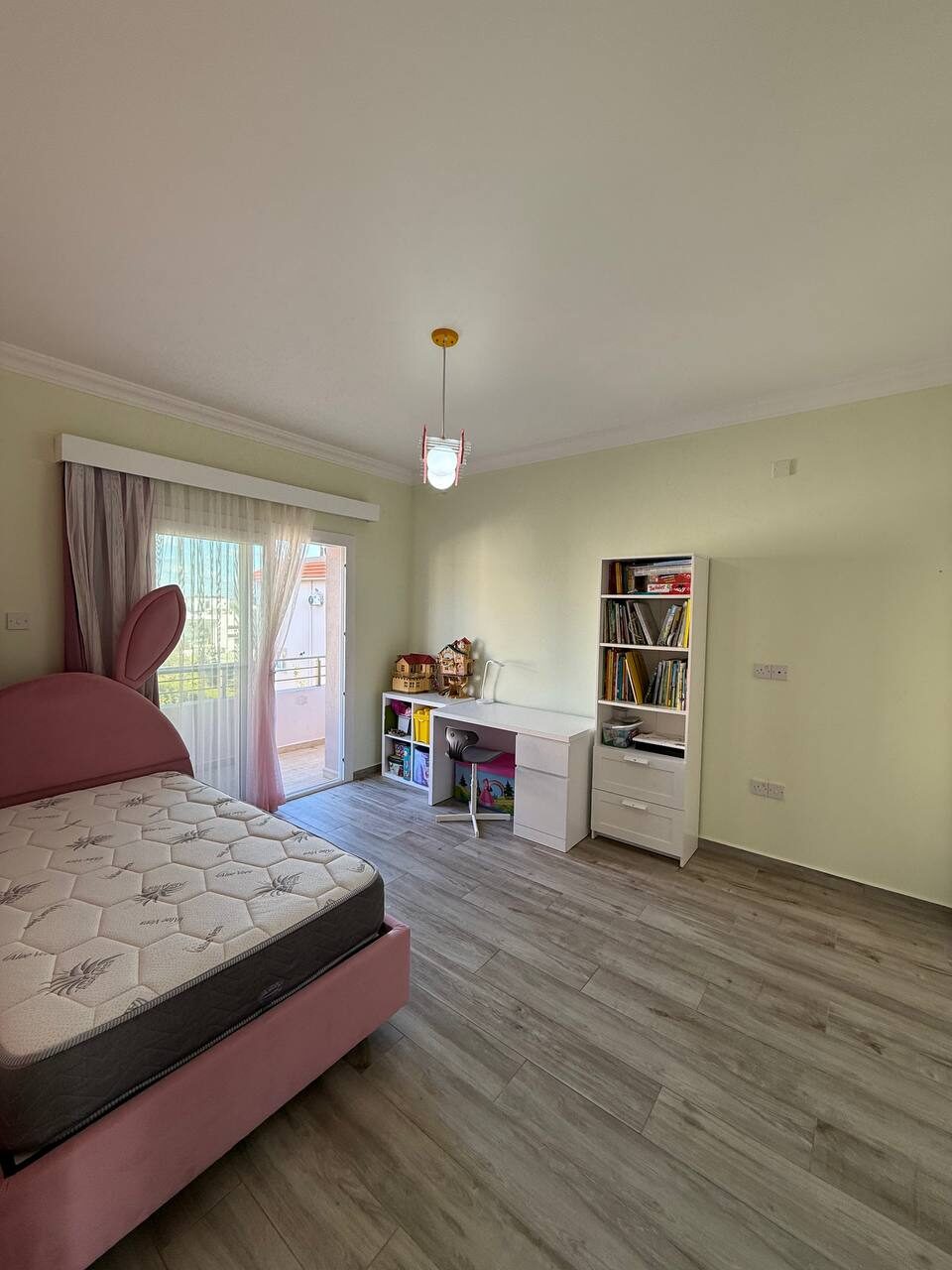 Child's room with a bed and bookshelves