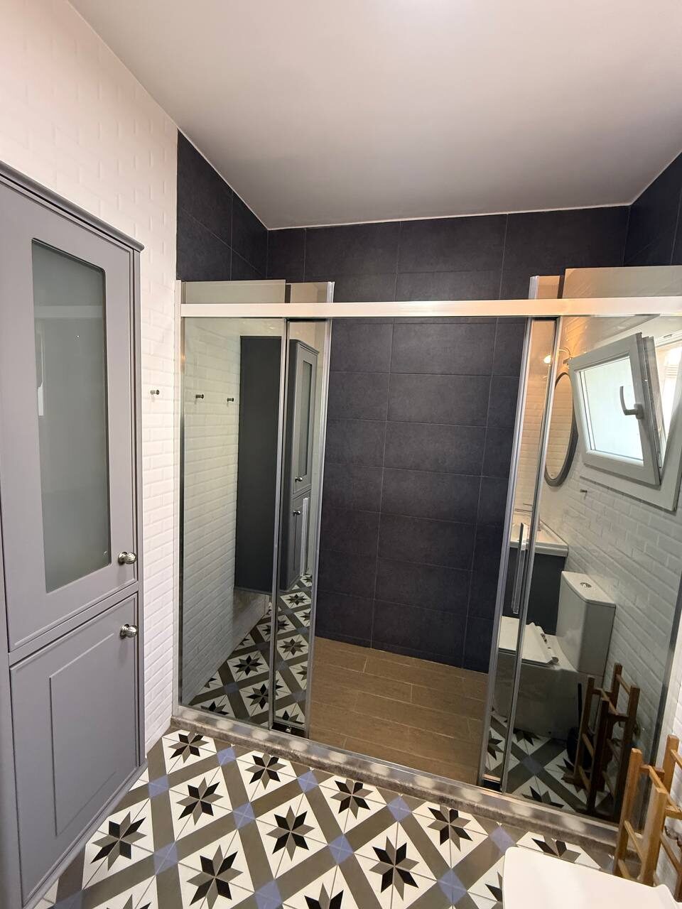 Bathroom with a sliding shower door and mirror