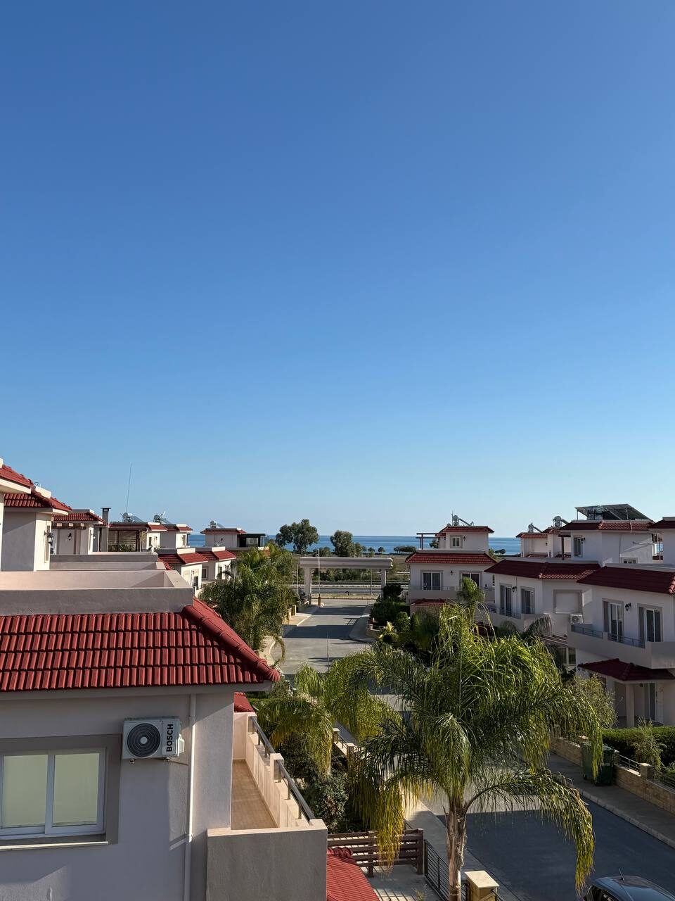 View from the upper floor over the rooftops towards the sea